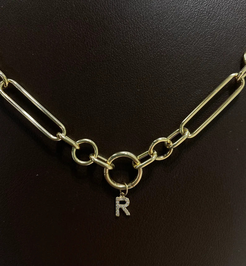 Round gold clasp with letter R